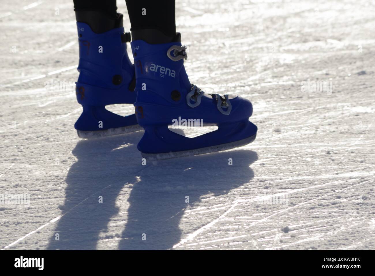 Ice Skaters at The Tower of London Ice Rink, UK. Close Up of Blue Ice