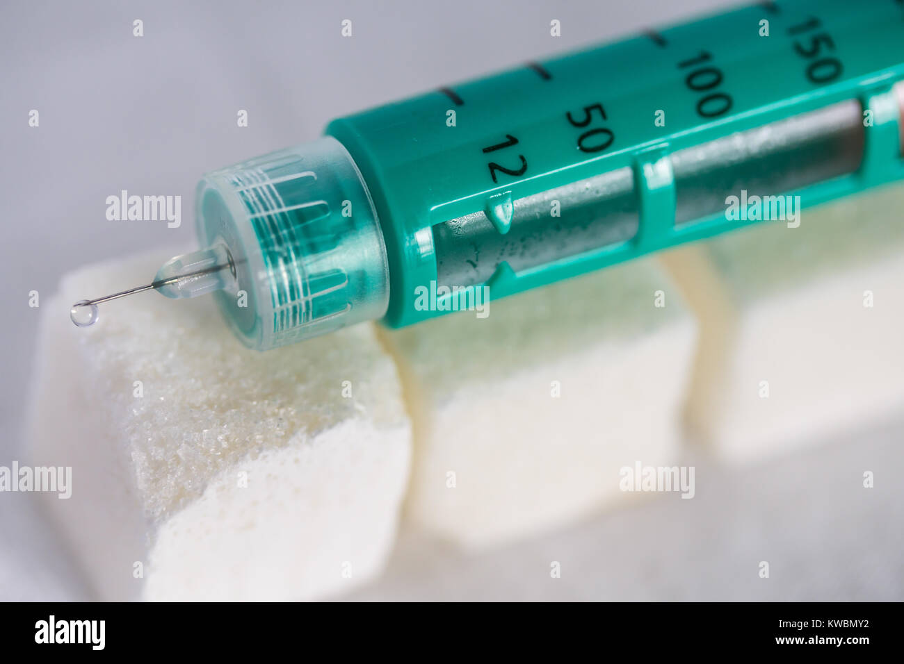Concept image of Diabetes issues with Diabetic Insulin pen on top of Sugar lumps Stock Photo