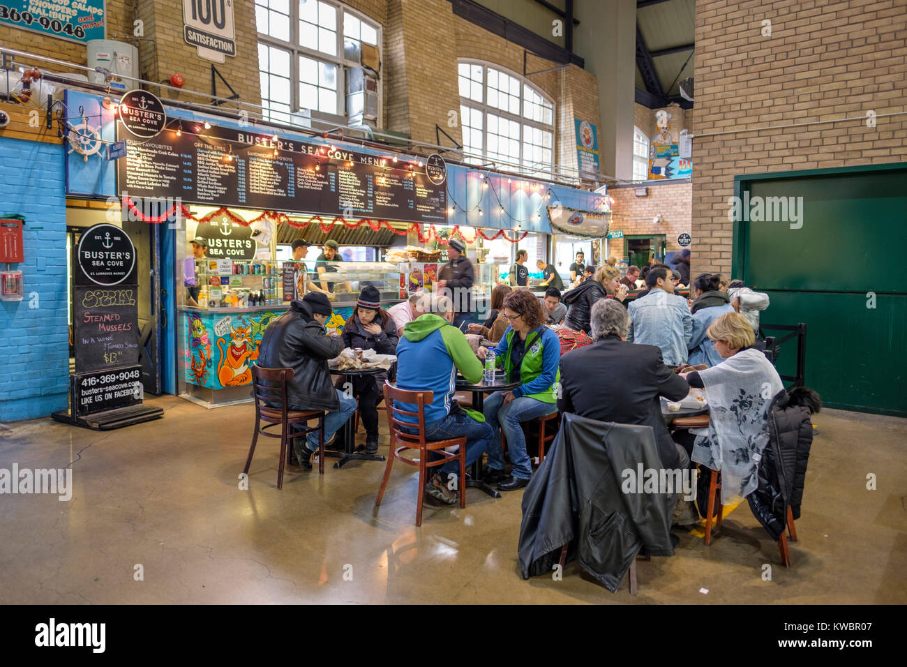 Customers having lunch at Buster's Sea Cove Restaurant, specialized in seafood, St Lawrence Market, downtown Toronto, Ontario, Canada. Stock Photo