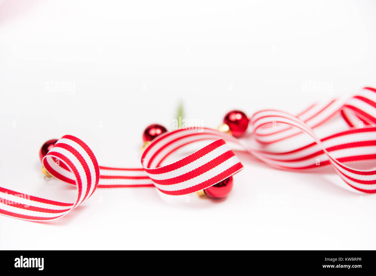 White and Red Striped Ribbon on White Background with Extra Space for