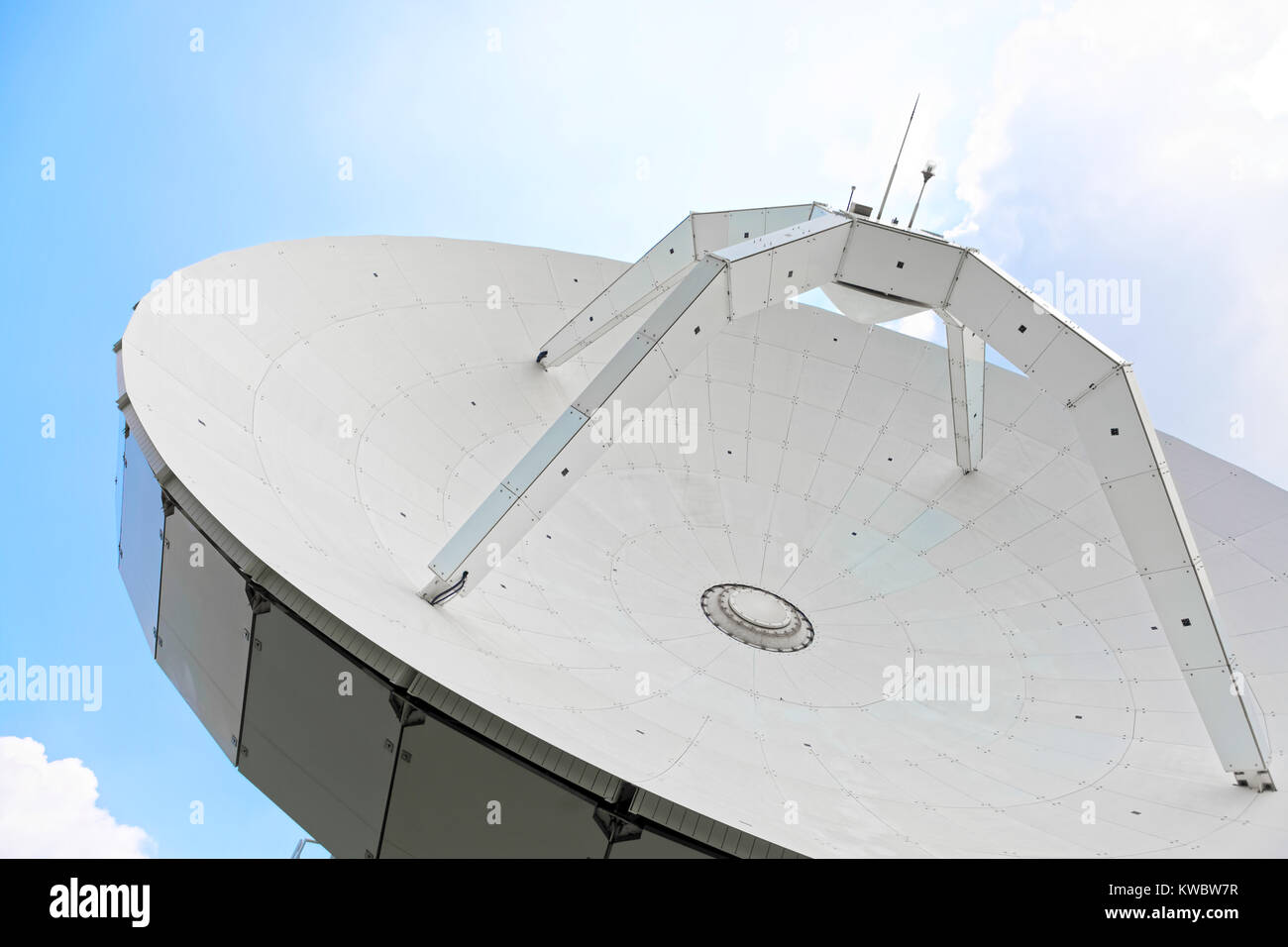 Parabolic antenna at a daytime with clear clue sky on background Stock Photo