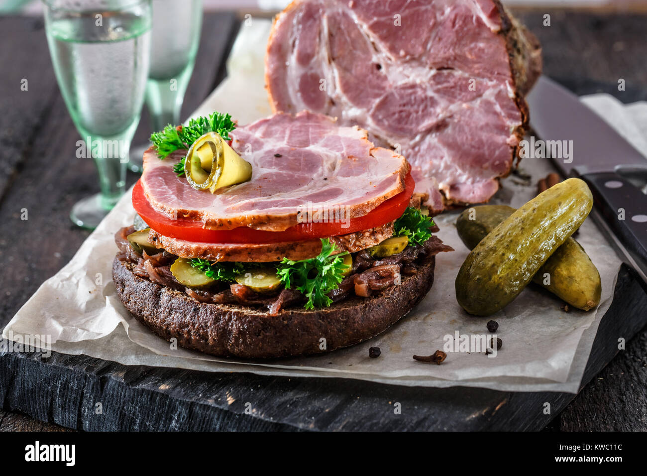 Opened homemade sandwich with smoked meat, tomato, onion jam and ico cold vodka Stock Photo Alamy