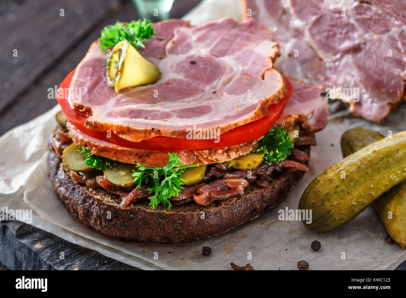 Opened homemade sandwich with smoked meat, tomato, onion jam and ico cold vodka Stock Photo Alamy