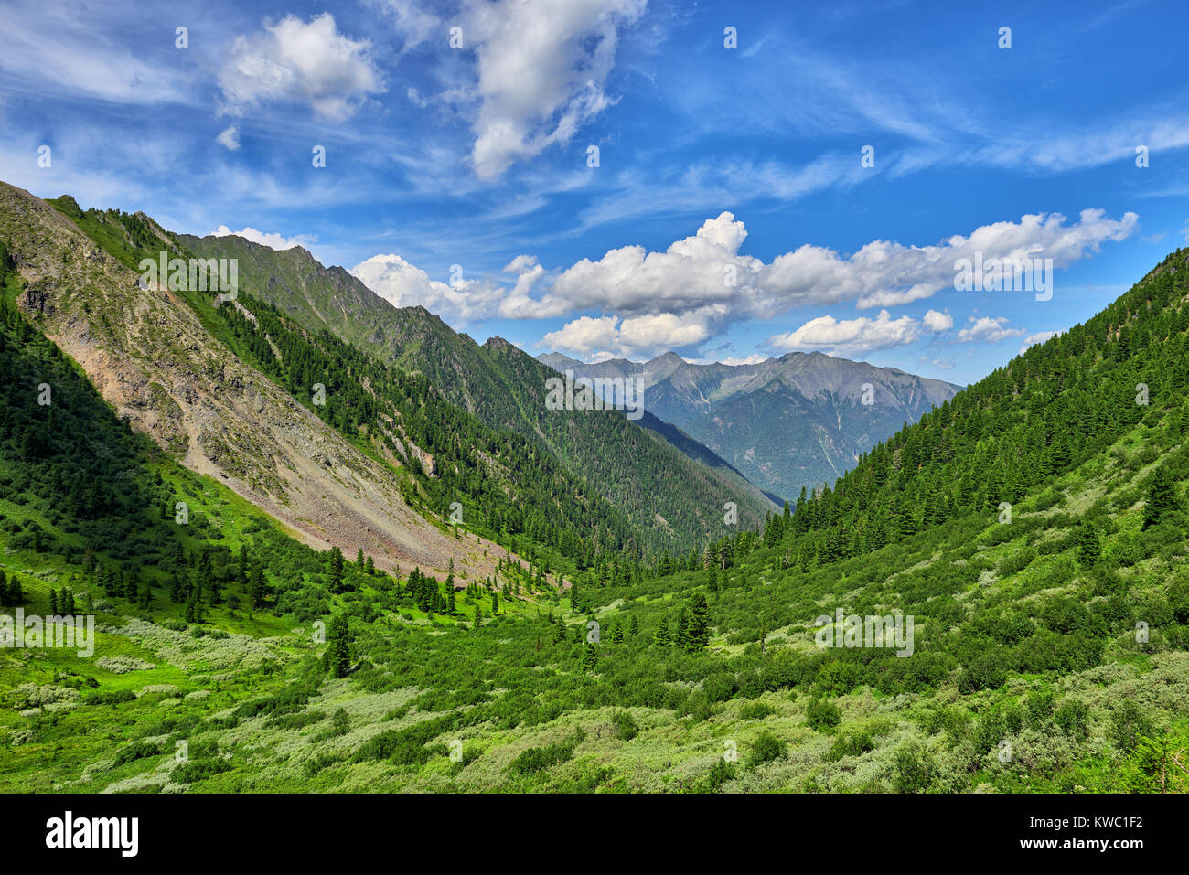 Beautiful clouds over green valley. Highlands in July. East Sayan. Russia Stock Photo