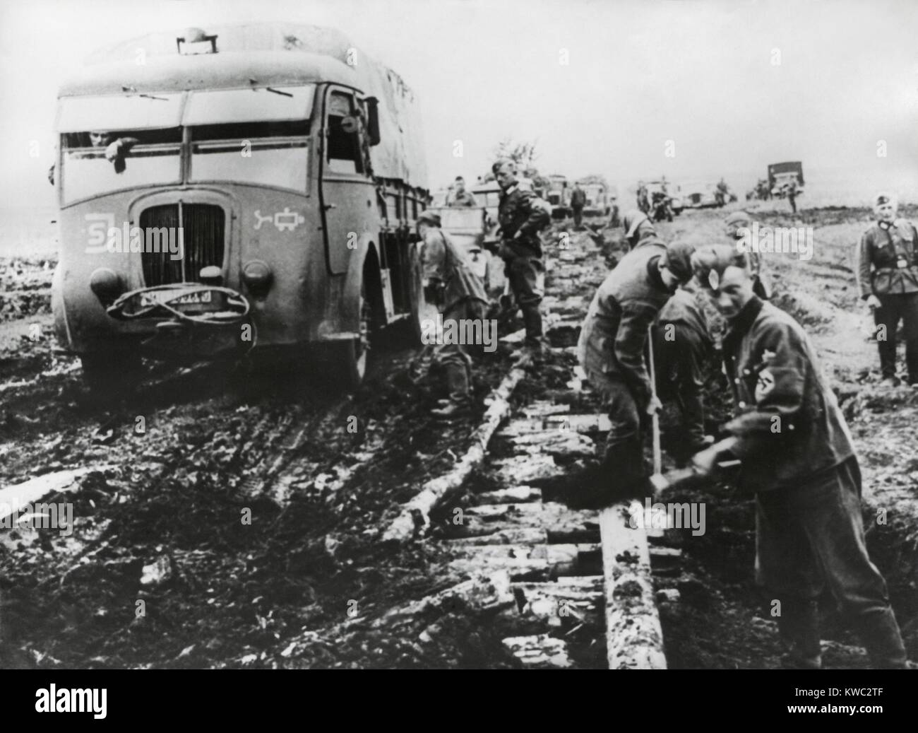 German army fights the autumn mud to supply the army in Stalingrad in Oct. 1942. Roadbuilders have laid logs to create a road bed, but it is still incomplete and unstable. World War 2 (BSLOC 2015 13 110) Stock Photo