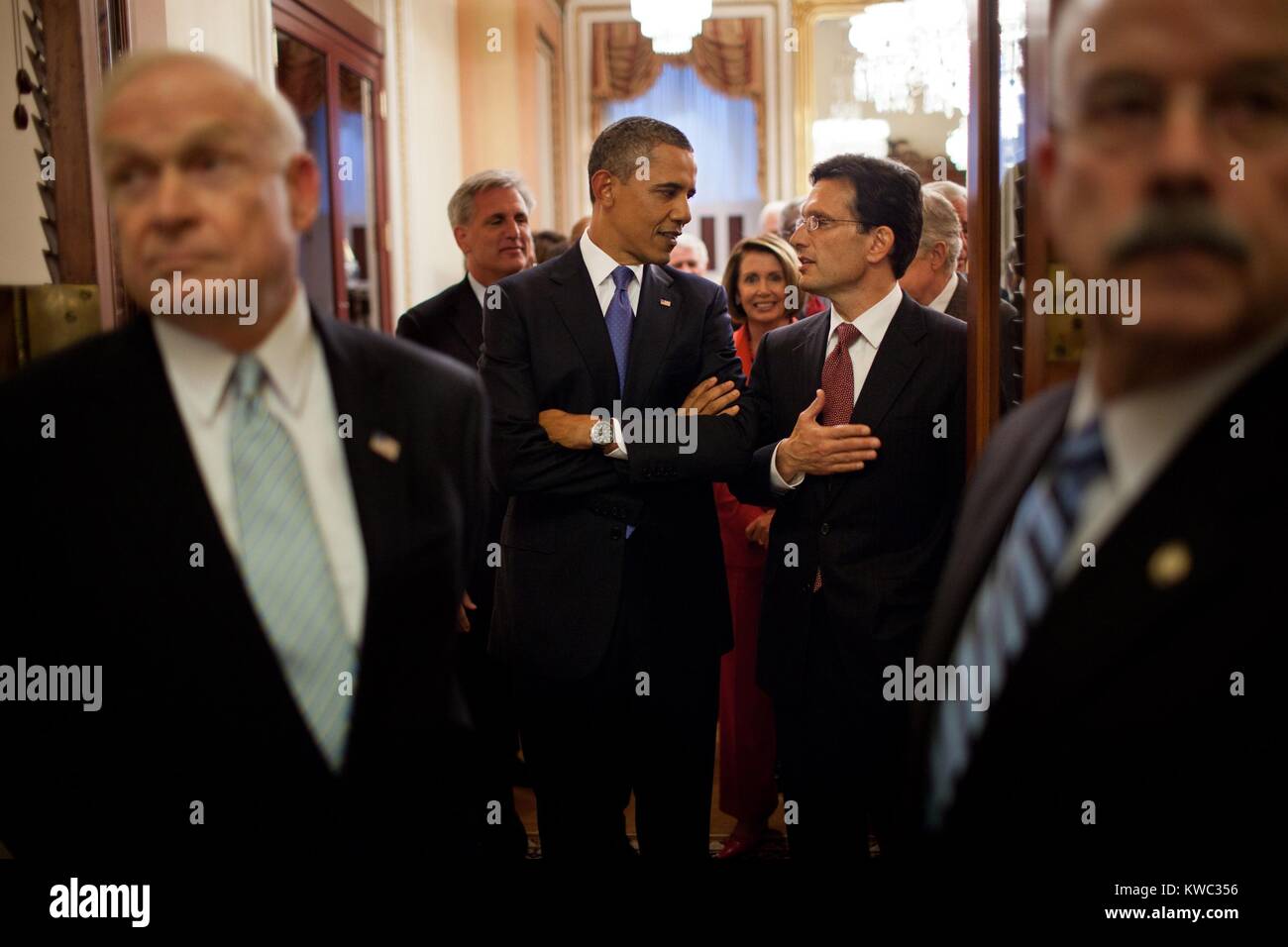 President Barack Obama talks with Rep. Eric Cantor, prior to entering the House Chamber. Sept. 8, 2011, before Obama's address to a Joint Session of Congress to outline the American Jobs Act. House Democratic leader Nancy Pelosi is in background. (BSLOC 2015 13 220) Stock Photo