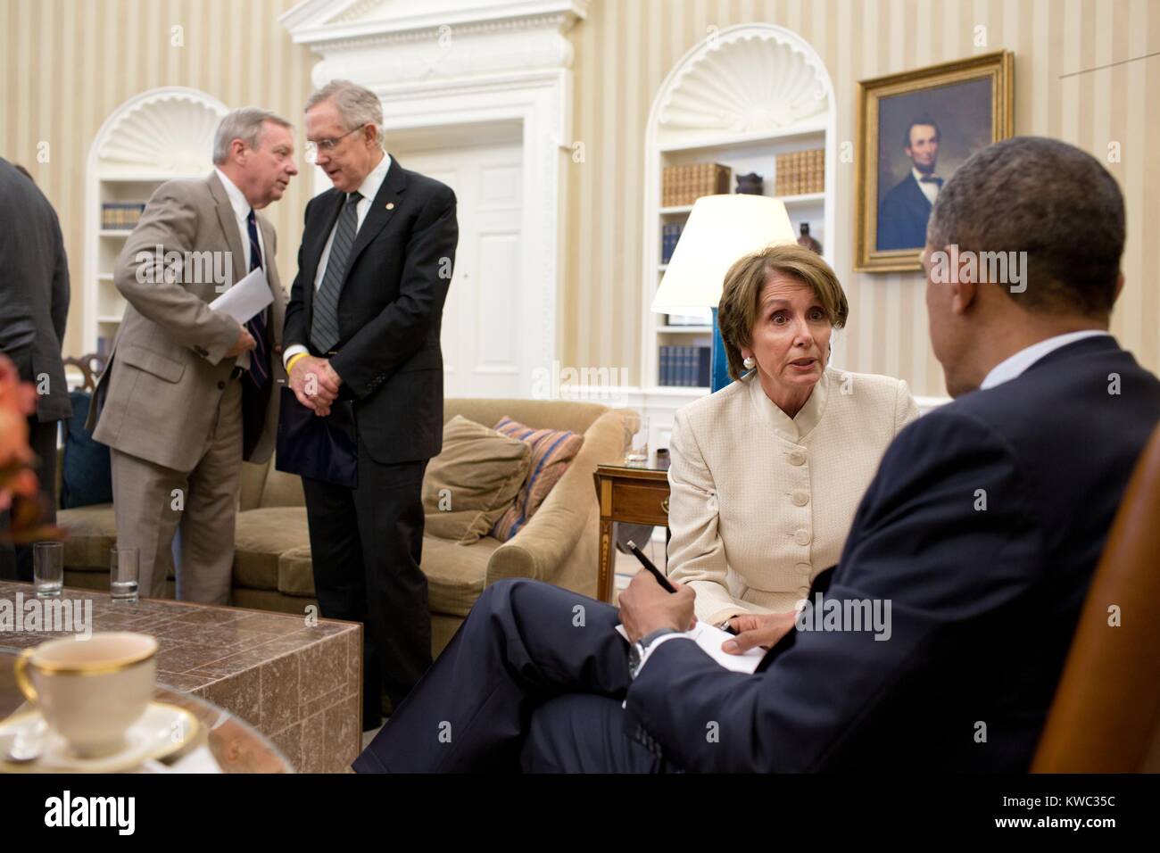 President Obama talks with House Minority Leader Nancy Pelosi, July 11, 2012. At left, Senate Majority Whip Dick Durbin talks with Senate Majority Leader Harry Reid. The group was in the Oval Office following a meeting with Democratic Leadership (BSLOC 2015 13 222) Stock Photo