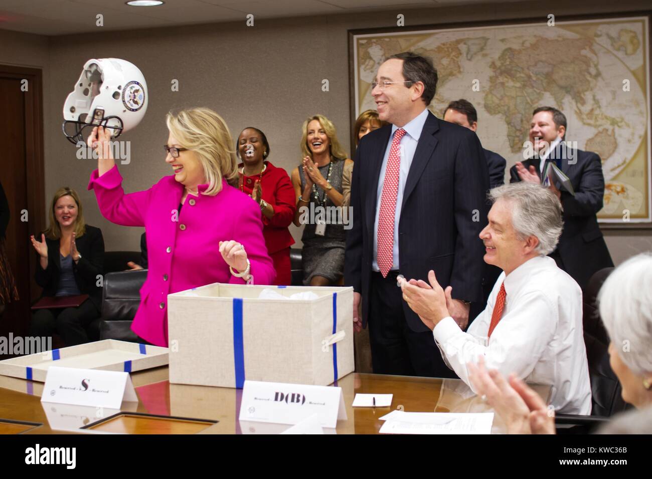 U.S. Sec. of State Hillary Clinton is presented with a football helmet at the State Department. Jan. 7, 2013 was her first day back to work after her head injury of Dec. 11, 2012. (BSLOC 2015 13 233) Stock Photo