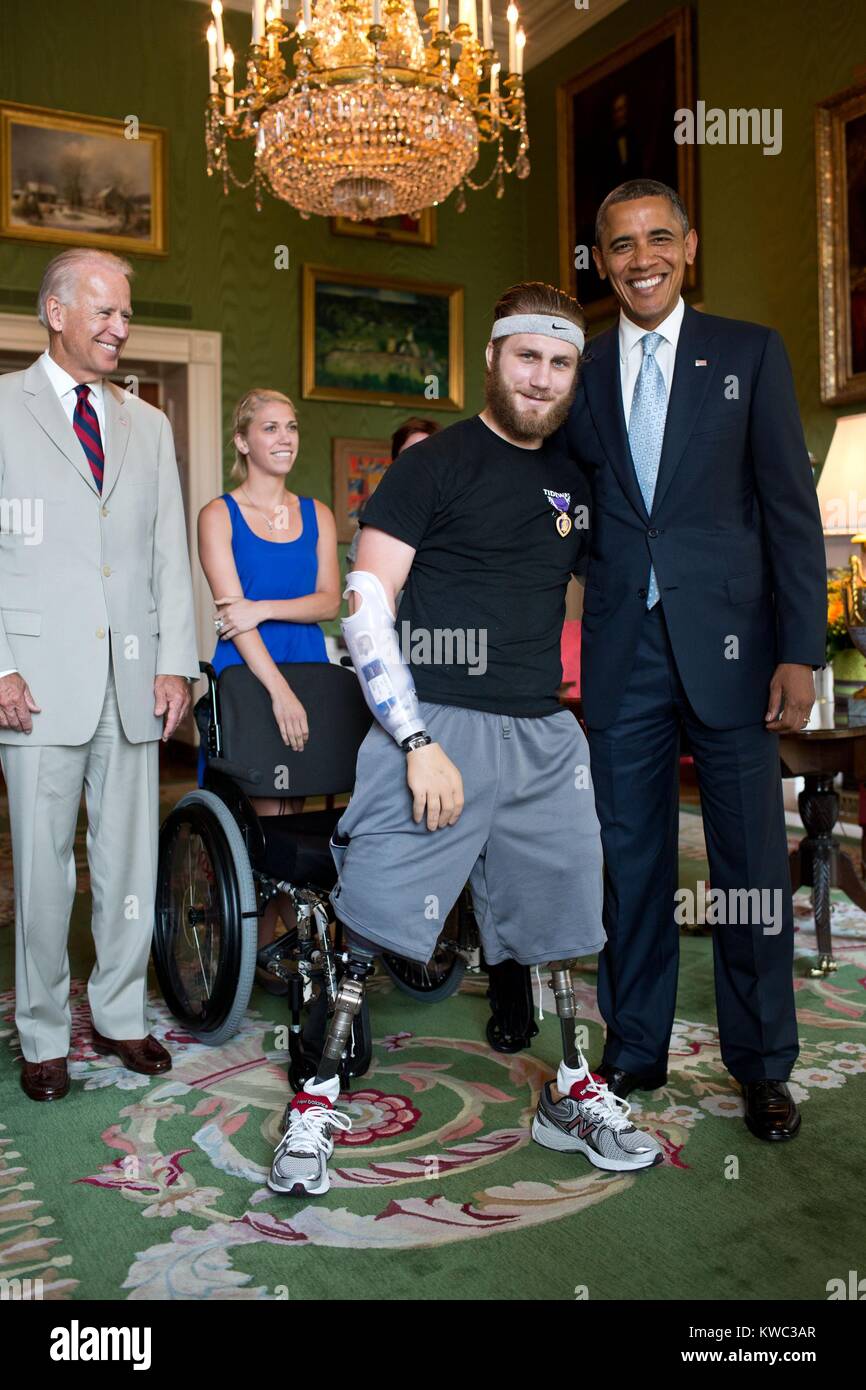Petty Officer Taylor Morris was presented with a Purple Heart by Pres. Barack Obama. Morris also received a Bronze Star for valorous conduct. A quadruple amputee wounded in Afghanistan, he is fitted with prosthetics that allow him to walk and a motorized hand. Green Room of the White House, July 26, 2012. (BSLOC 2015 13 281) Stock Photo
