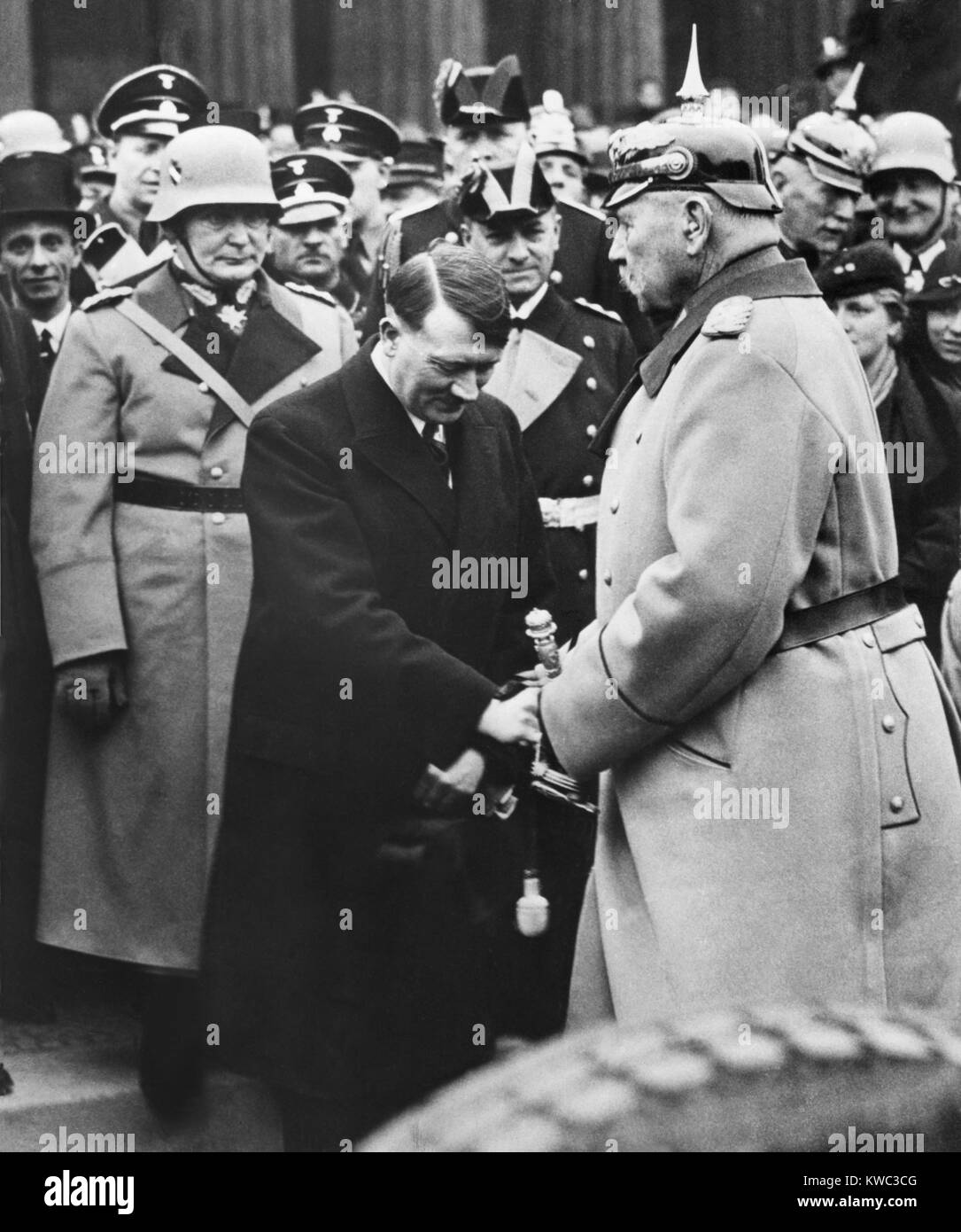 Newly appointed Chancellor Adolf Hitler greets President von Hindenburg at a memorial service. Berlin, 1933. Behind Hitler is Herman Goering and Joseph Goebbels. (BSLOC 2015 13 44) Stock Photo