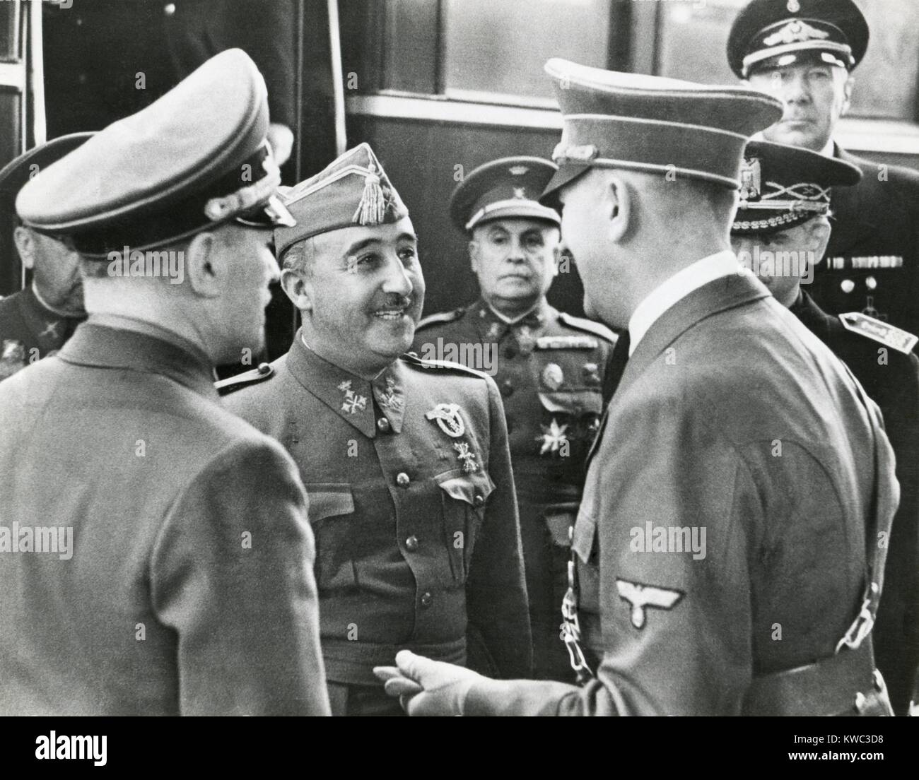 Spanish Fascist dictator Francisco Franco and Adolf Hitler meet for the first time, Oct. 23, 1940. In their 9 hour conference, Hitler urged Franco join him in World War 2 conflict. Franco countered that his country needed food, weapons, and gasoline before he could enter the war. Spain remained neutral throughout WW2. (BSLOC 2015 13 55) Stock Photo