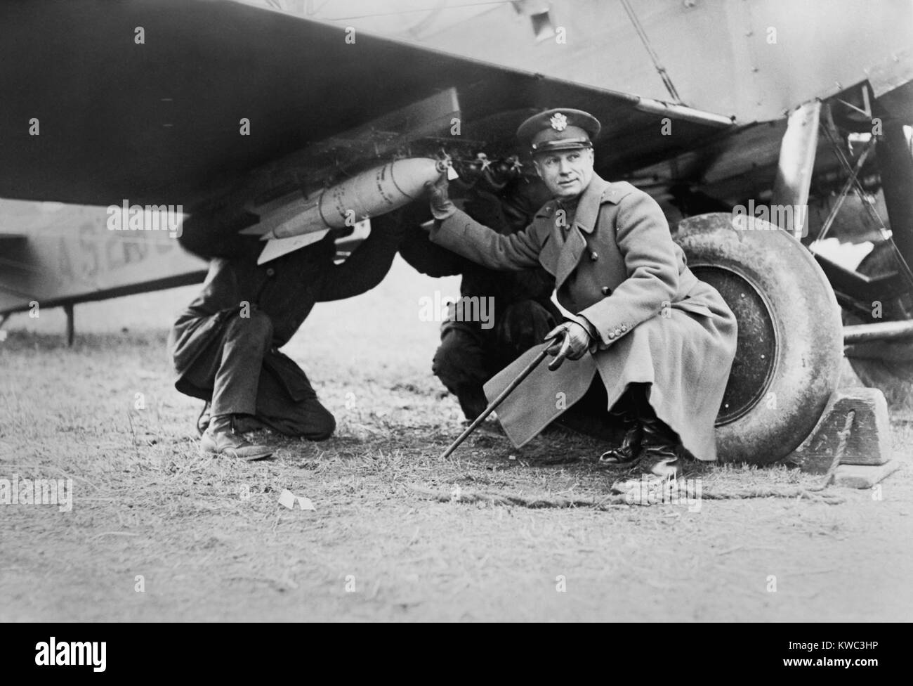 Brigadier General Billy Mitchell and another man, attaching a bomb under wing of airplane. Ca. 1925. He advocated military aviation and foresaw the vulnerability of ships to aerial bombing. His fervor resulted in a court-martial for insubordination and his resignation. (BSLOC 2015 14 111) Stock Photo