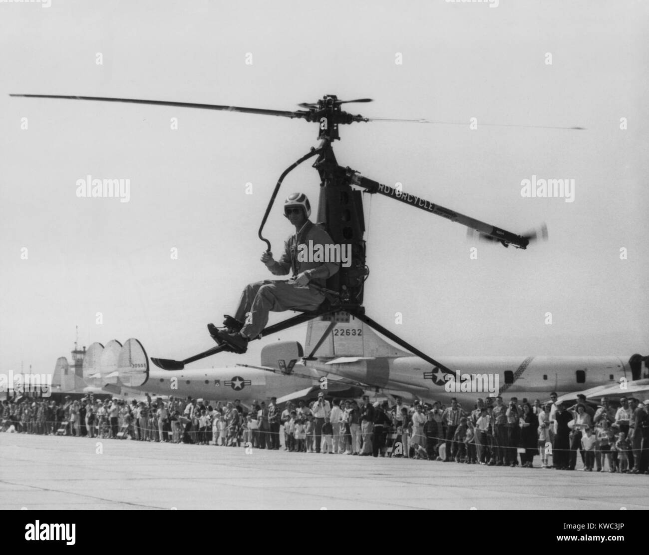 Rotocycle, 250-pound collapsible, one-man helicopter in demonstration flight in 1957-58. It was developed for the Marines to use for observation, liaison, and maneuvers. The Marines rejected it because of its slow speed of 52 mph, minimal range of 40 miles, vulnerability to small-arms fire, and the lack of visual references on the structure causing the pilot spatial disorientation. (BSLOC 2015 14 124) Stock Photo