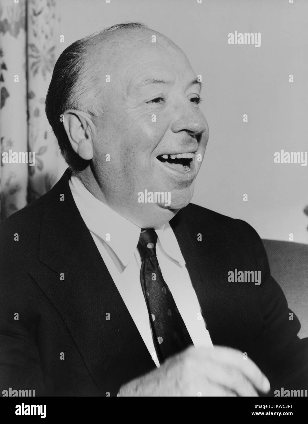 Film director Alfred Hitchcock laughing, 1956. (BSLOC 2015 14 170) Stock Photo