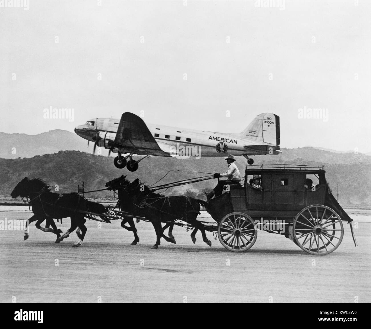 American Airlines DC-3 flying past horse drawn stagecoach. The photo was featured in an American Airlines magazine advertisement in 1949. (BSLOC 2015 14 193) Stock Photo