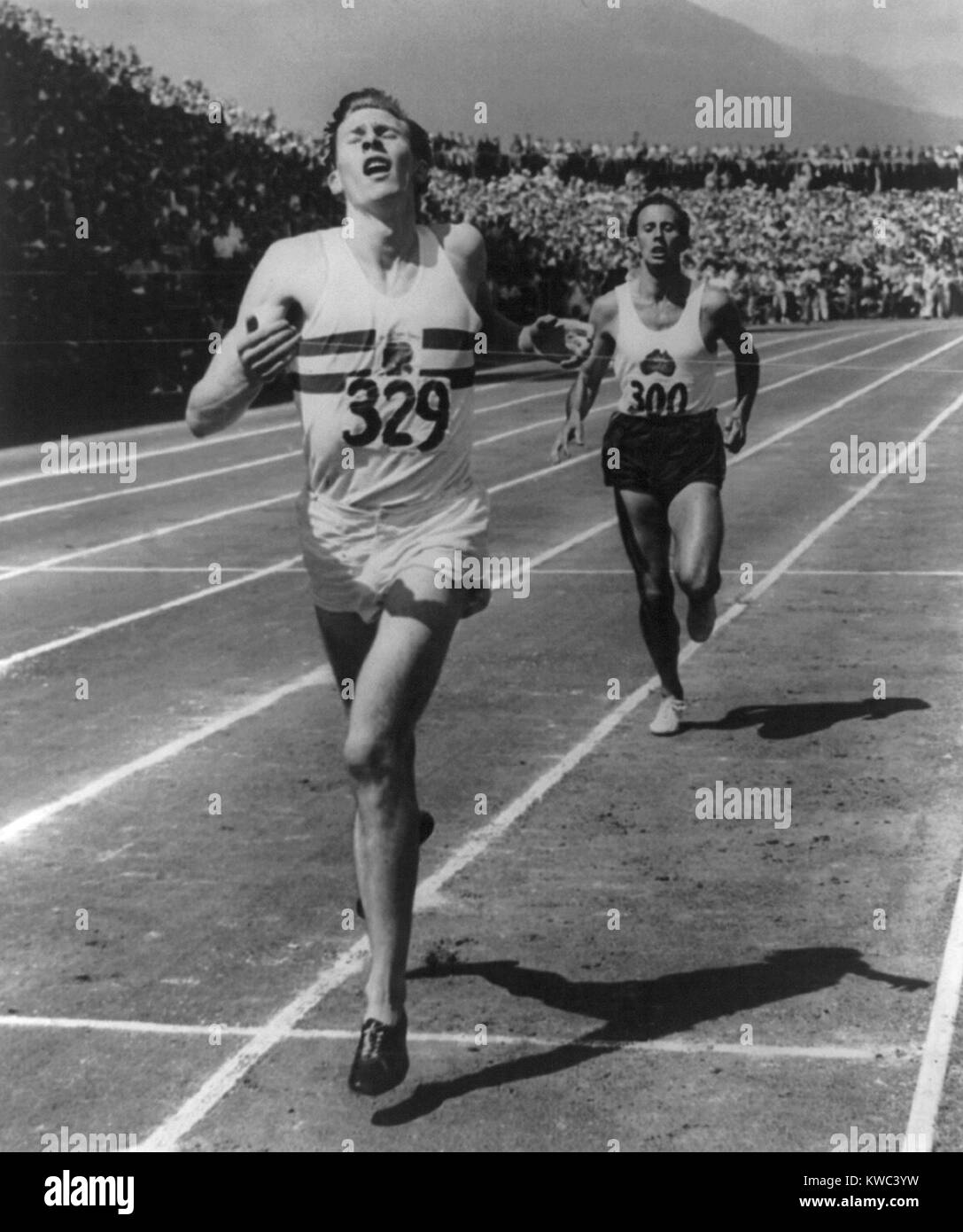 Roger Bannister leads John Landy of Australia across the finish line at British Empire Games, 1954. It was the first mile race in history in which two runners finished under four minutes. Vancouver, B.C. (BSLOC 2015 14 218) Stock Photo