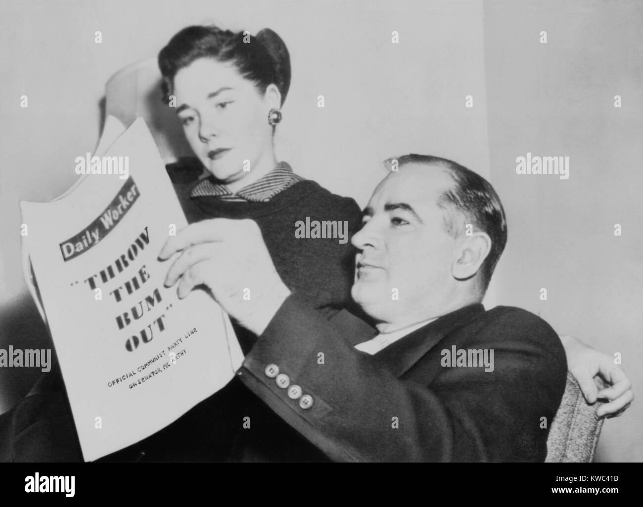 Sen. and Mrs. Joseph R. McCarthy at home as the Senate prepared to his censure. Nov. 8, 1954. They are reviewing Photostats of the Communist 'Daily Worker' urging the U.S. Senate to 'Throw the bum out.' (BSLOC 2015 14 27) Stock Photo
