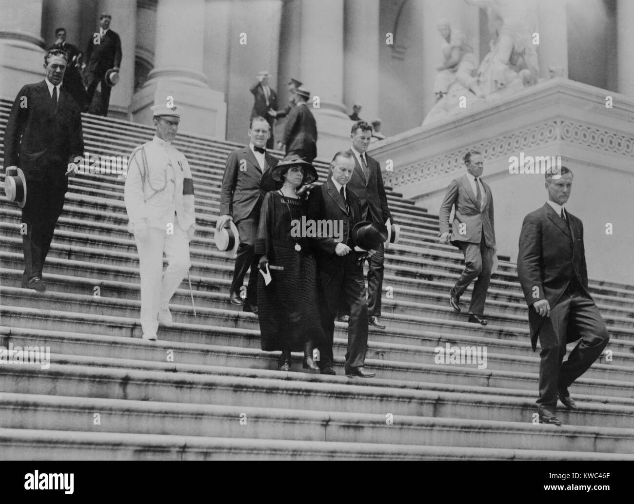 President Calvin Coolidge and the First Lady leave the Capitol after Warren Harding funeral. August 8, 1923. President Coolidge wore a formal suit with silk edging, while some near him are wearing standard business suit. (BSLOC 2015 15 104) Stock Photo