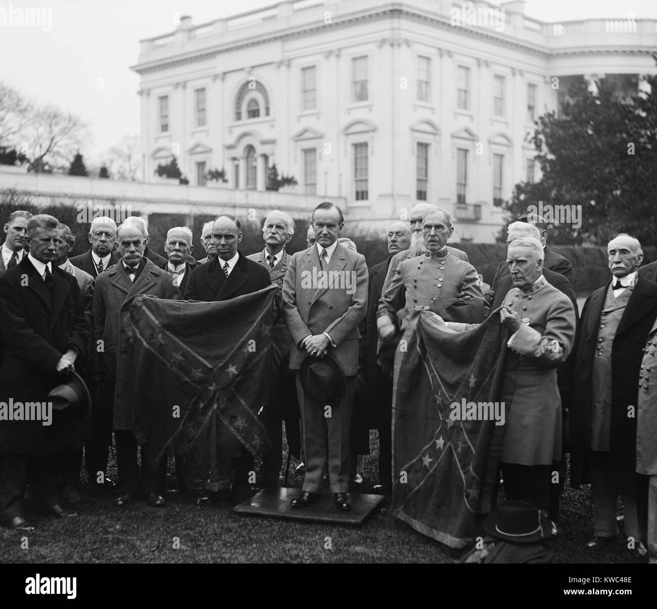 President Calvin Coolidge with Confederate group holding 'Star and Bars' flag. White House, Dec. 1927. (BSLOC 2015 15 128) Stock Photo