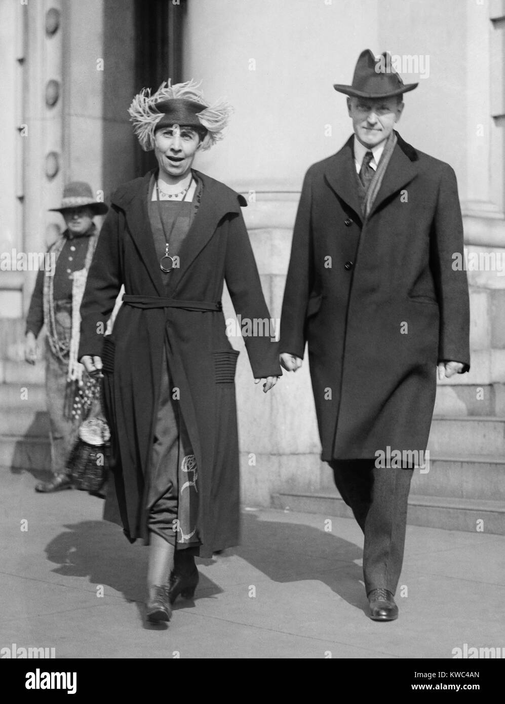 Vice President Elect Calvin Coolidge and wife Grace walking on Washington, D.C. street. The outgoing Grace Coolidge speaks to the photographer on March 1, 1921. They moved into the Willard Hotel suite vacated by the departing Vice President, Thomas Marshall, and lived there until Coolidge became President in August 1923. (BSLOC 2015 15 152) Stock Photo