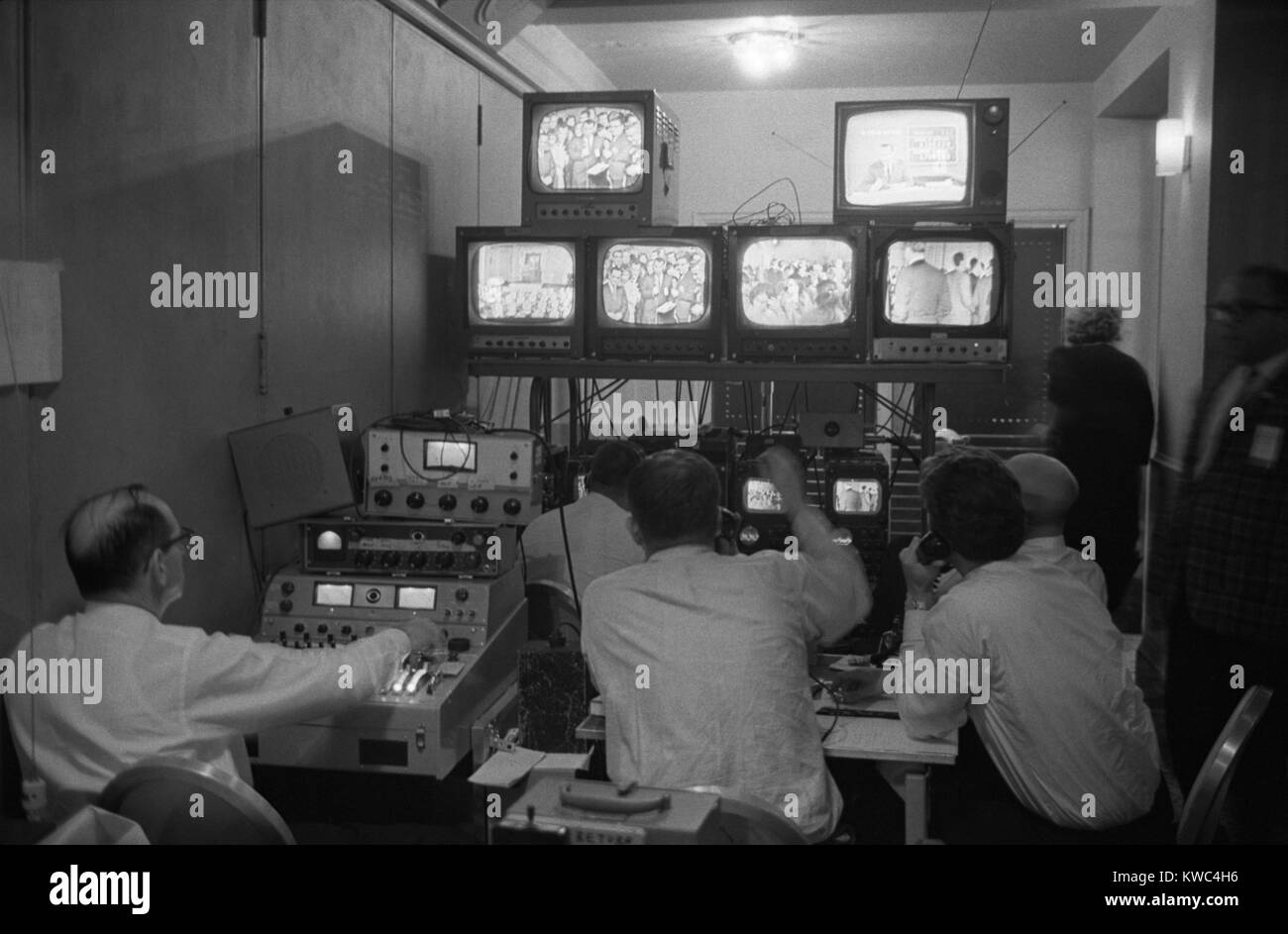 Broadcasting technicians, seated in front of bank of television sets at the Democratic Headquarters. Election Night, November 3, 1964, at the Mayflower Hotel in Washington, D.C. (BSLOC_2015_2_215) Stock Photo