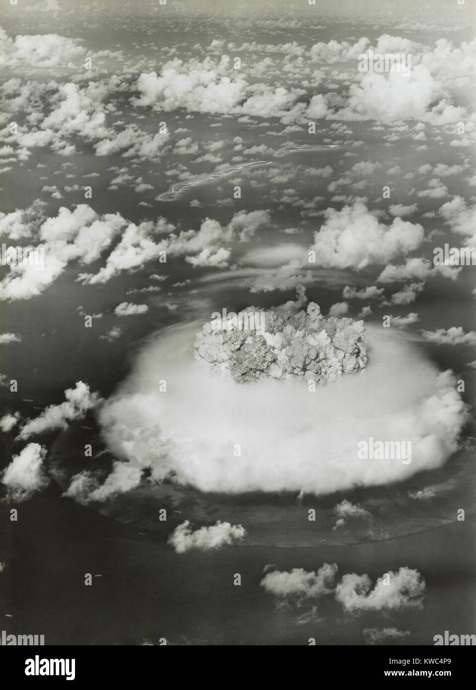 The BAKER test of Operation Crossroads, July 25, 1946. BAKER was exploded underwater, creating an underwater pressure of 1000 pounds per square inch. Operation Crossroads tested the effects of atomic weapons on ships at sea. The ABLE shot, detonated above the target was far less damaging than BAKER. BAKER created a tremendous underwater shock wave and deadly nuclear fall out. (BSLOC 2015 2 5) Stock Photo