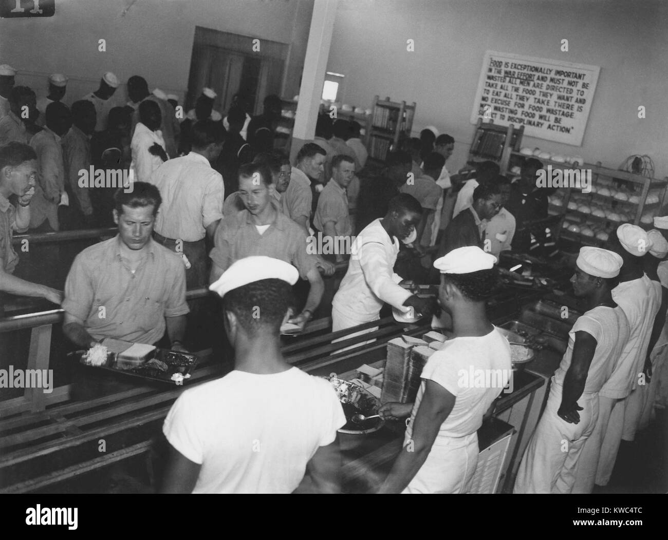African America enlisted men in Mess Hall serving whites first at Hastings, Nebraska, 1944. In June 1944, racial conflict erupted at the Hastings Naval Ammunition Depot which produced over one-third of munitions for the U.S. Navy. This photo was taken in the investigation that followed. World War 2 (BSLOC 2015 13 100) Stock Photo