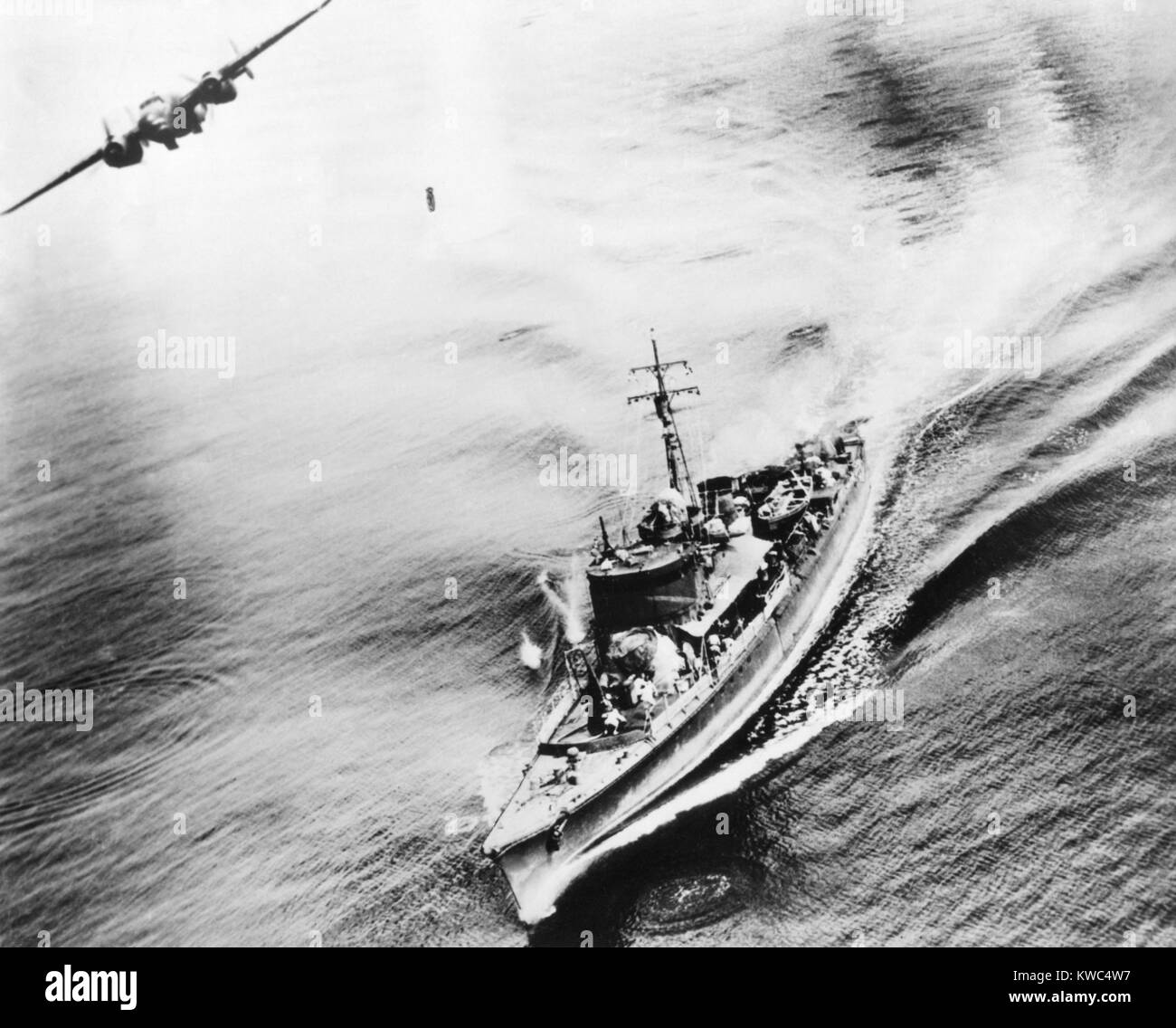 Small Japanese war vessel bombed by U.S. B-25 bomber in the Bismarck Sea, March 21, 1944. The ships crew can be seen running for cover. The ship was sunk by the attack near New Ireland. World War 2 (BSLOC 2015 13 121) Stock Photo