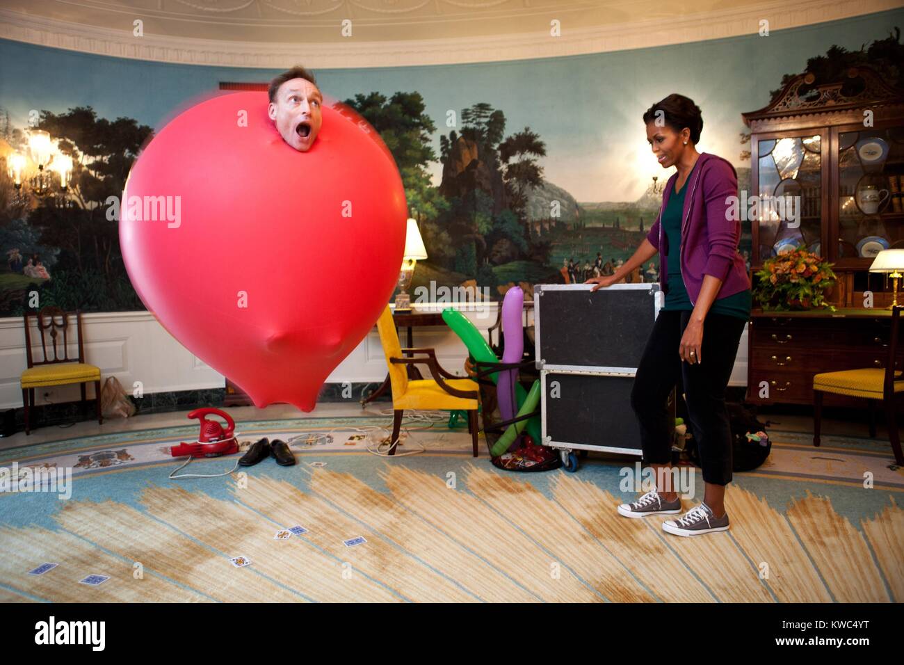 John Cassidy in a six-foot red balloon in the Diplomatic Reception Room with Michelle Obama. White House, Oct. 11, 2011. (BSLOC 2015 13 187) Stock Photo
