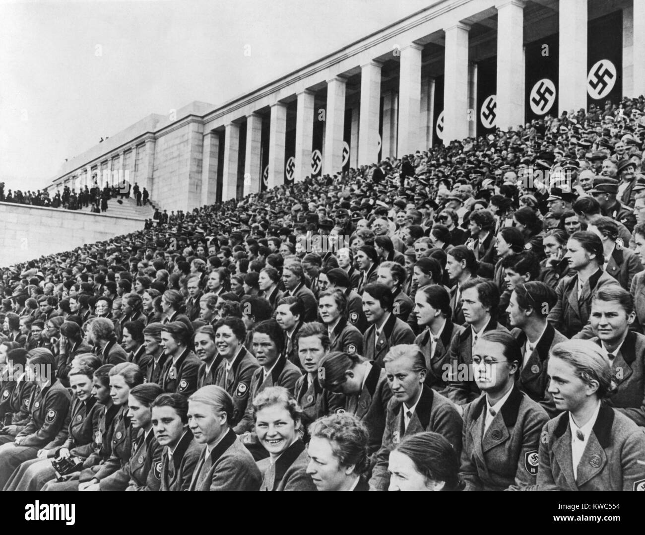 Uniformed young women with Nazi insignia in the Zeppelin Grandstand at Nuremberg. The stadium was on the Nazi Party Rally Grounds designed by Hitler's architect, Albert Speer. Ca. 1937-1940. (BSLOC 2015 13 51) Stock Photo