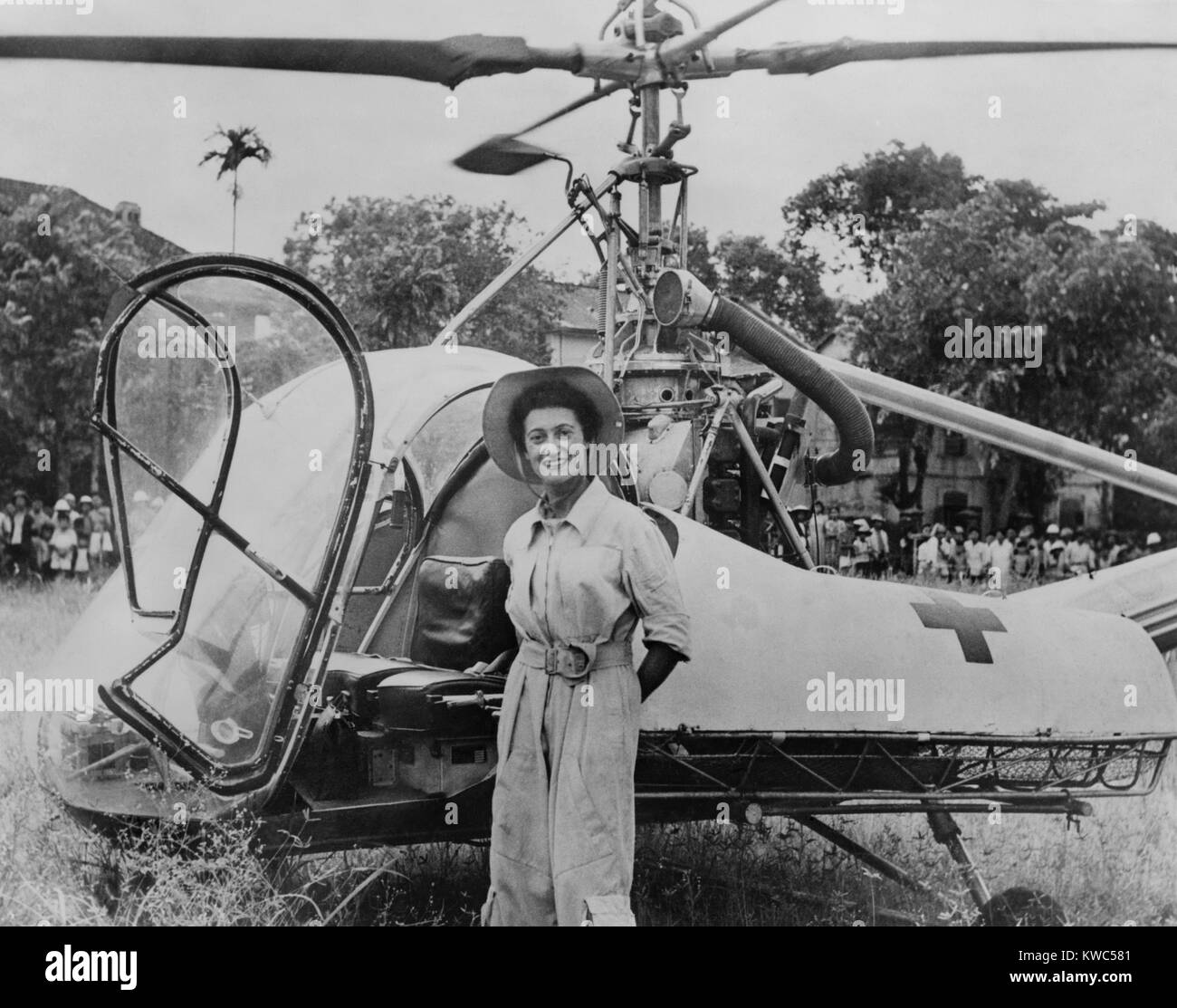 Dr. Valerie Andre, in front of her helicopter in Tonkin, Vietnam, in 1952. She served in the French army as a neurosurgeon, and learned to fly helicopters to reach wounded soldiers. From 1952-53, she rescued 165 soldiers and parachuted to treat wounded needing immediate surgery. In 1976 she became the first Women to reach the rank of General Officer in the French Army. (BSLOC 2015 14 120) Stock Photo
