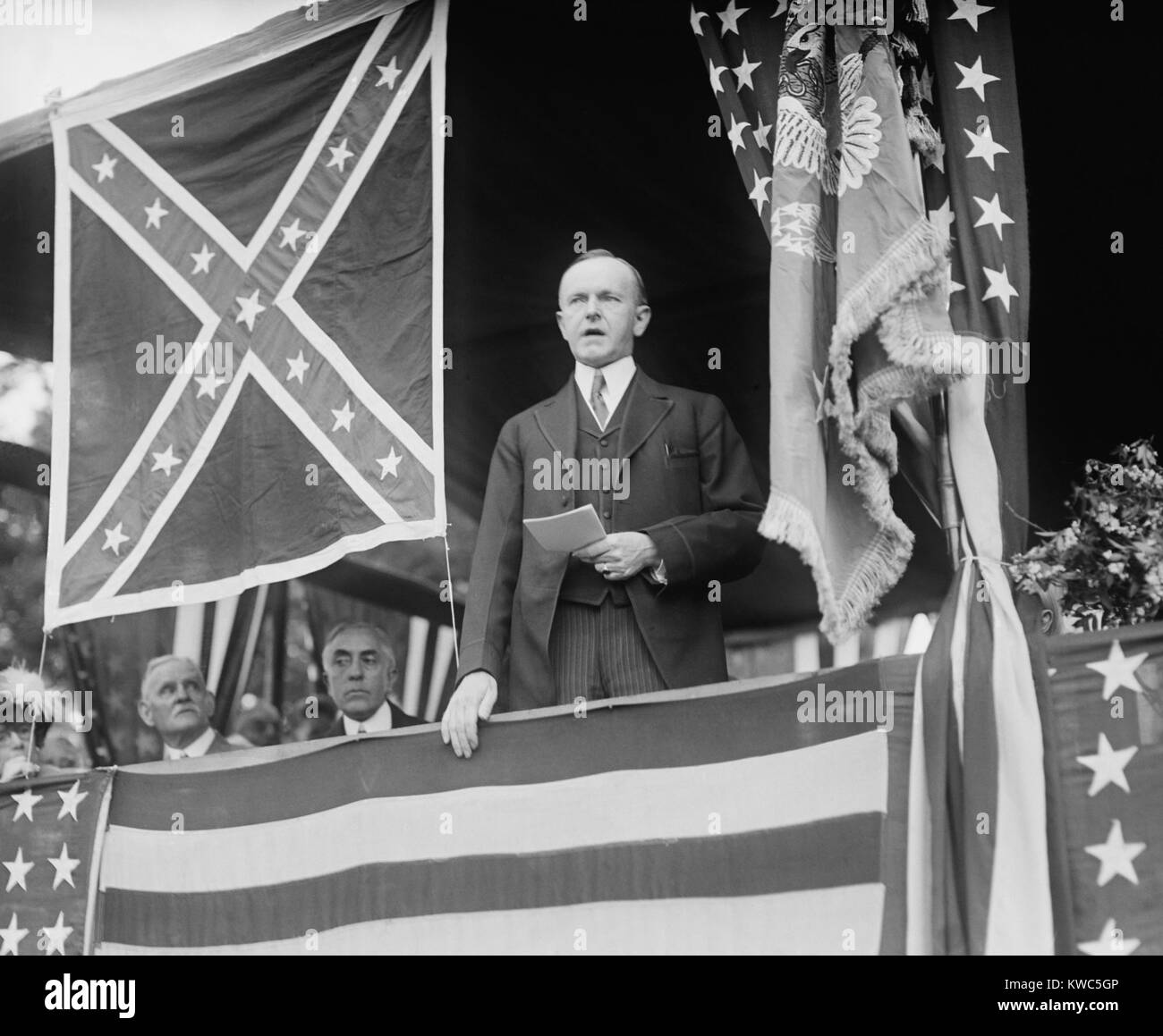 President Calvin Coolidge speaking beside Confederate flag at Arlington Cemetery. May 24, 1924. (BSLOC 2015 15 126) Stock Photo