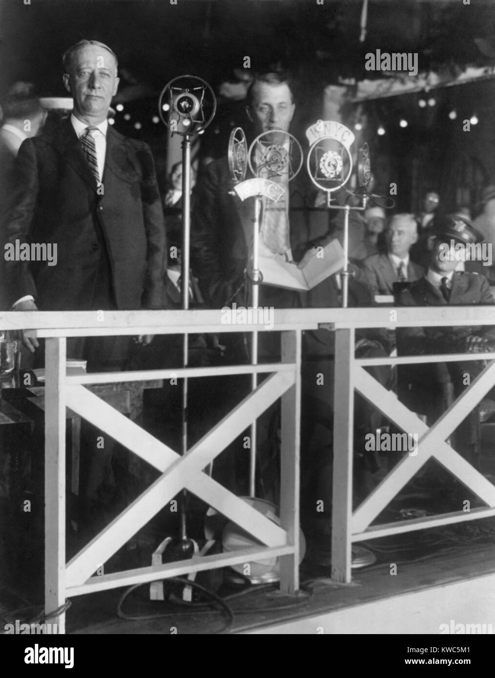 Gov. Alfred E. Smith speaking at City Hall, New York. Smith, the Democratic Presidential Candidate was introduced to a crowd and thousands of radio listeners by Graham McNamee. Smith, the first Roman Catholic nominated for President by a major party, pleaded for religious tolerance. (BSLOC 2015 15 206) Stock Photo