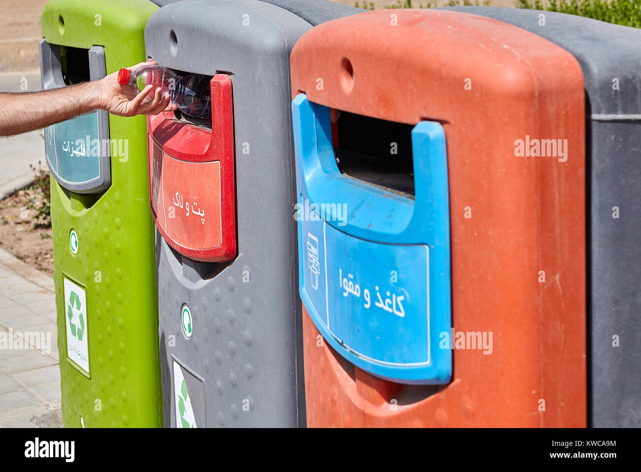 Three wheelie bins in three different colours used for separated waste