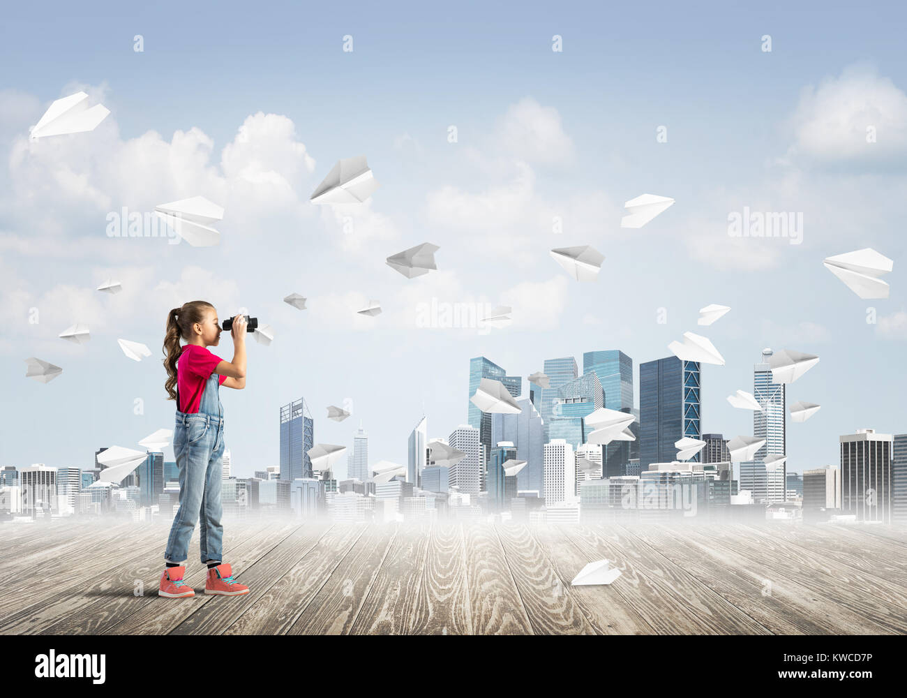 Cute kid girl stand on wooden floor and paper planes flying around ...