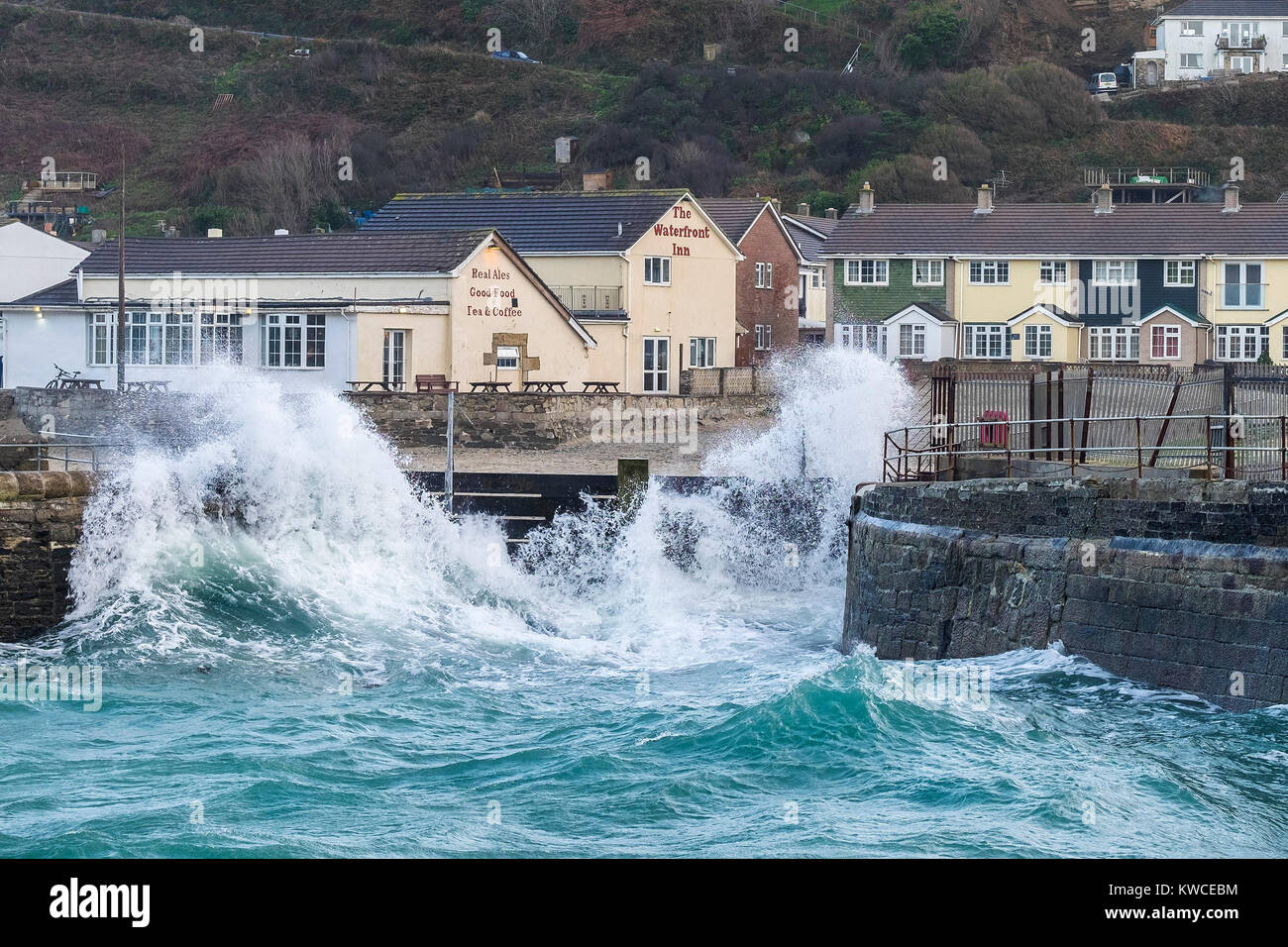 UK weather - stormy sea battering the flood defences at Portreath harbour in Cornwall. Stock Photo