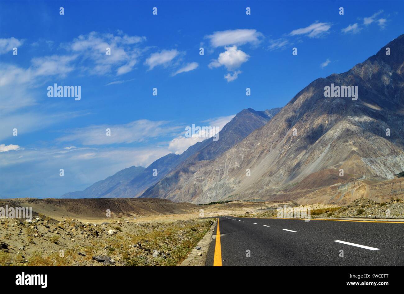 Clean and long road, Clear weather hilly view near valley of Chillas Pakistan. Stock Photo