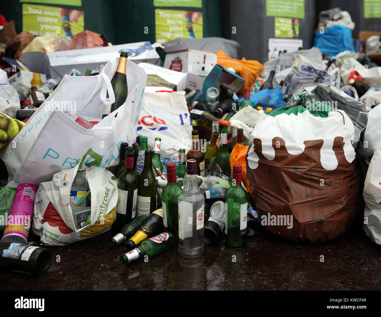 Empty bottles dumped in front of glass recycling bins at a centre near