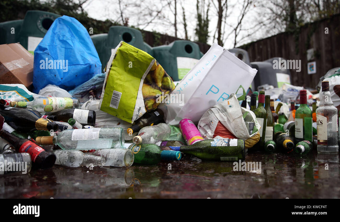Empty bottles dumped in front of glass recycling bins at a centre near