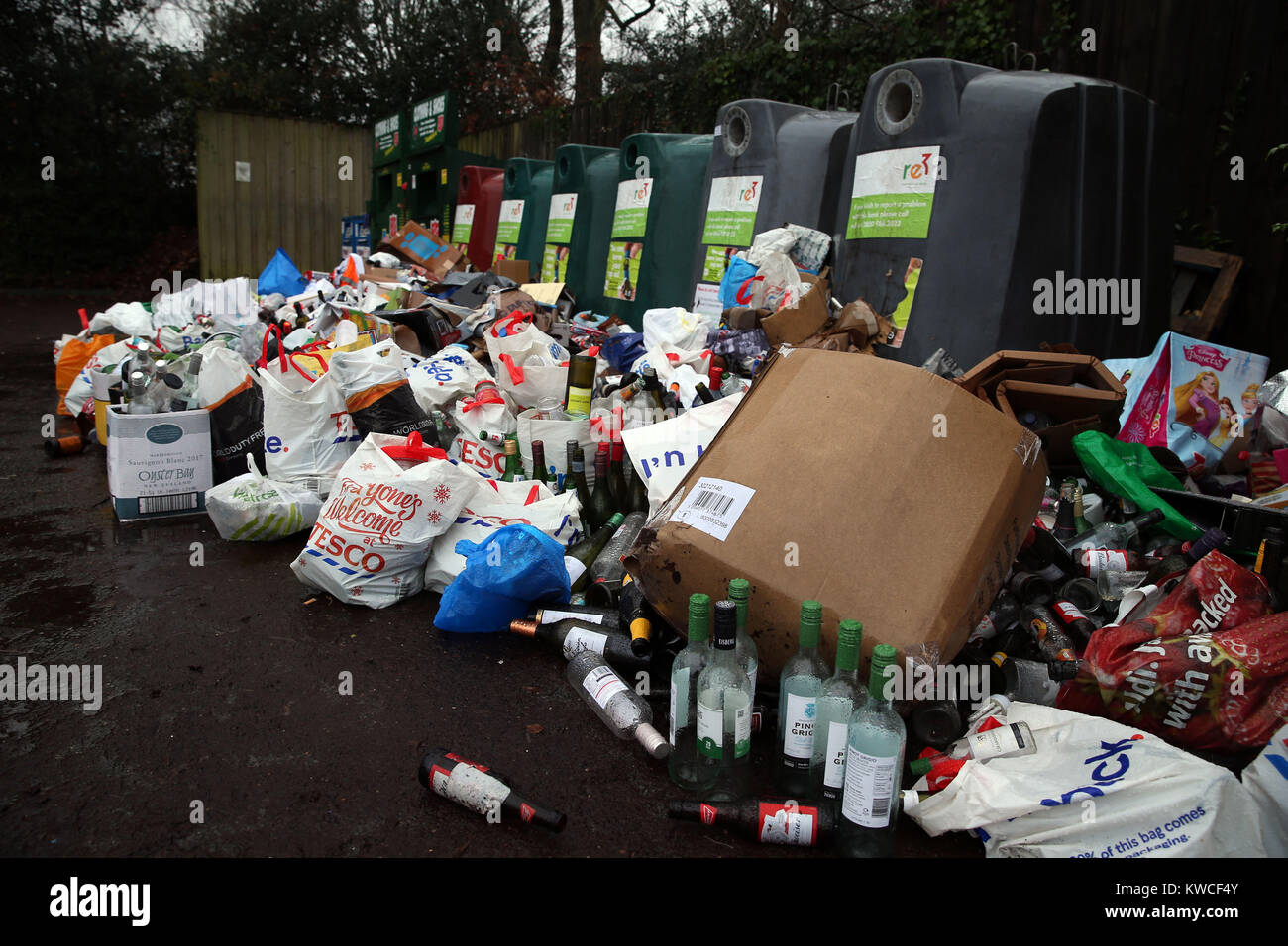 Empty bottles dumped in front of glass recycling bins at a centre near