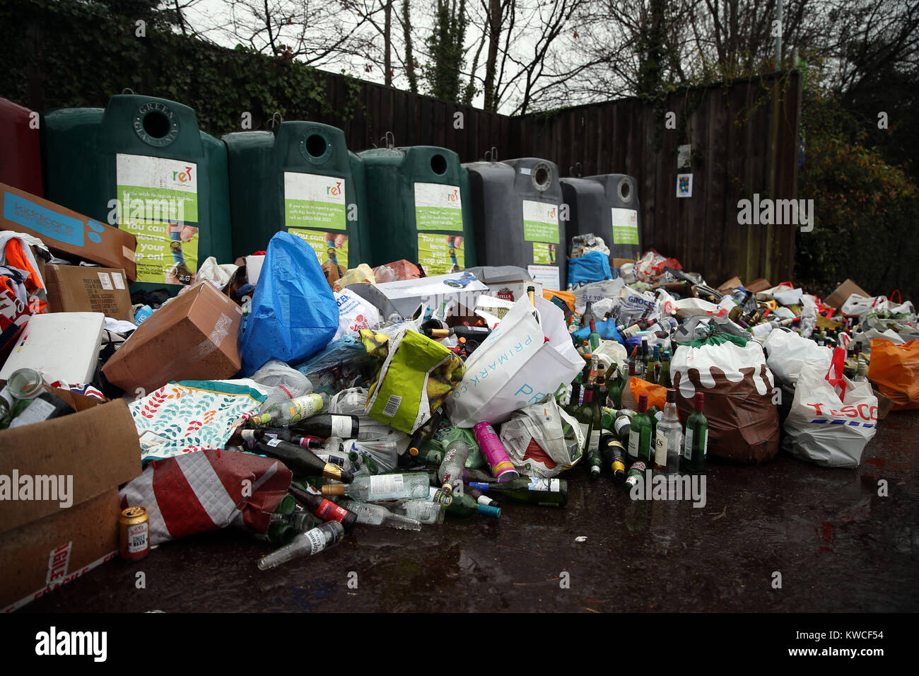Empty bottles dumped in front of glass recycling bins at a centre near