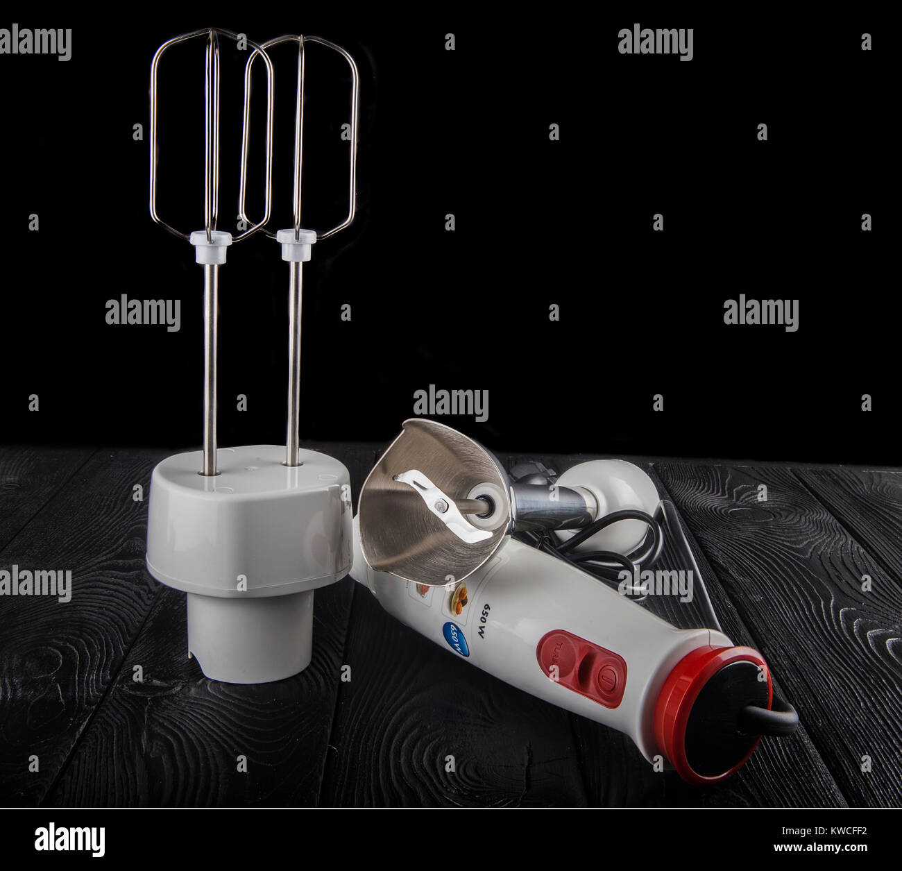 Electric hand blender, isolated on a black background Stock Photo Alamy