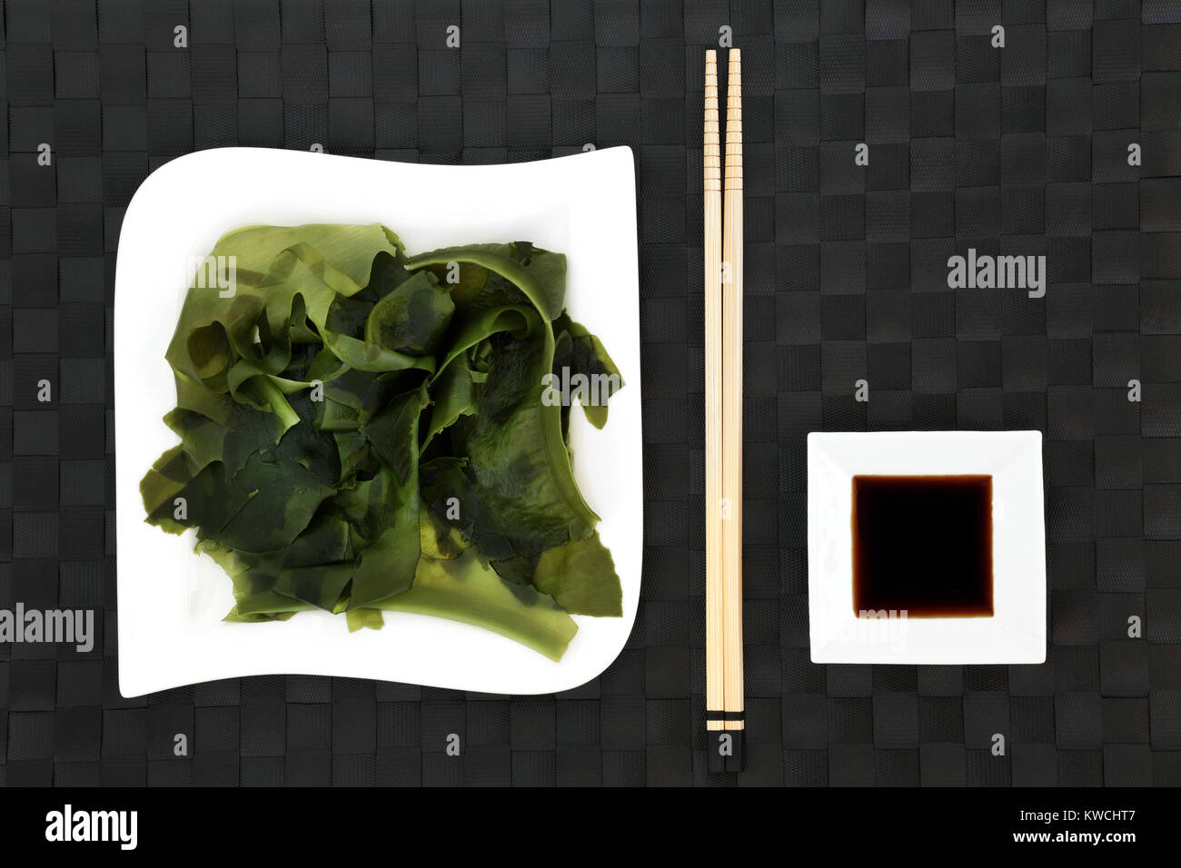 Japanese wakame seaweed health food with low sodium soy sauce on porcelain dishes with chopsticks. Has many benefits for a healthy life. Stock Photo