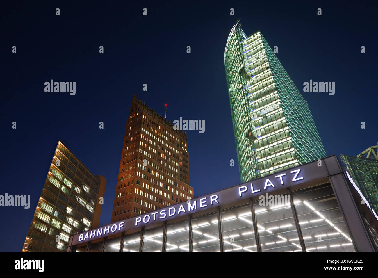Potsdamer Platz train station entrance and skyscrapers at night Stock