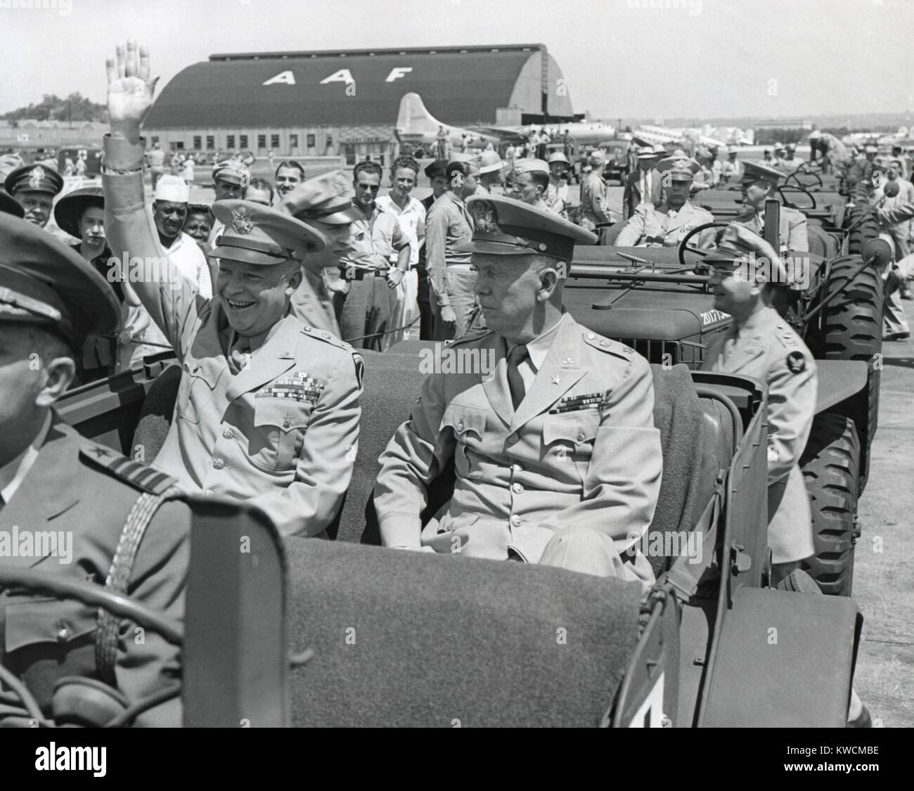 Generals Dwight Eisenhower and George Marshall sitting in a jeep at a Washington D.C. airport. Eisenhower is waving and smiling, contrasting with the restrained Marshall. June 18, 1945. - (BSLOC 2014 15 117) Stock Photo