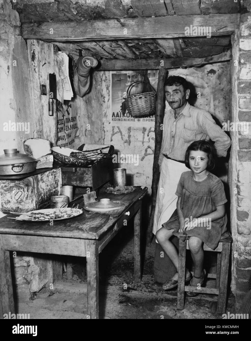 Father and daughter in sparse refugee quarters during the Greek Civil War. August 29, 1947. - (BSLOC 2014 15 225) Stock Photo