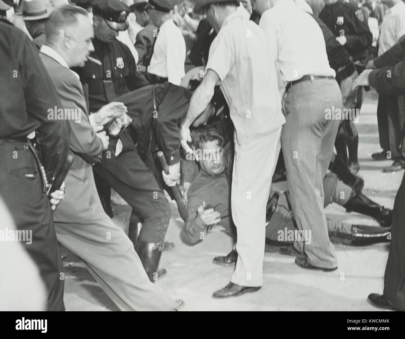 State trooper on the ground after he was hit by a rioter's rock during the Paul Robeson concert. Peekskill, N.Y. Sept. 4, 1949. An earlier August 27th concert was canceled when a mob attacked concert-goers, seriously injuring 13 with baseball bats and rocks. The concert benefited the Civil Rights Congress. (BSLOC 2014 13 68) Stock Photo
