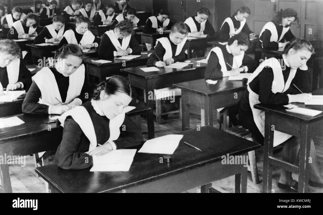 Soviet female graduates from the tenth grade writing compositions for their diplomas. Yaroslavl, USSR. 1948. - (BSLOC 2014 15 251) Stock Photo