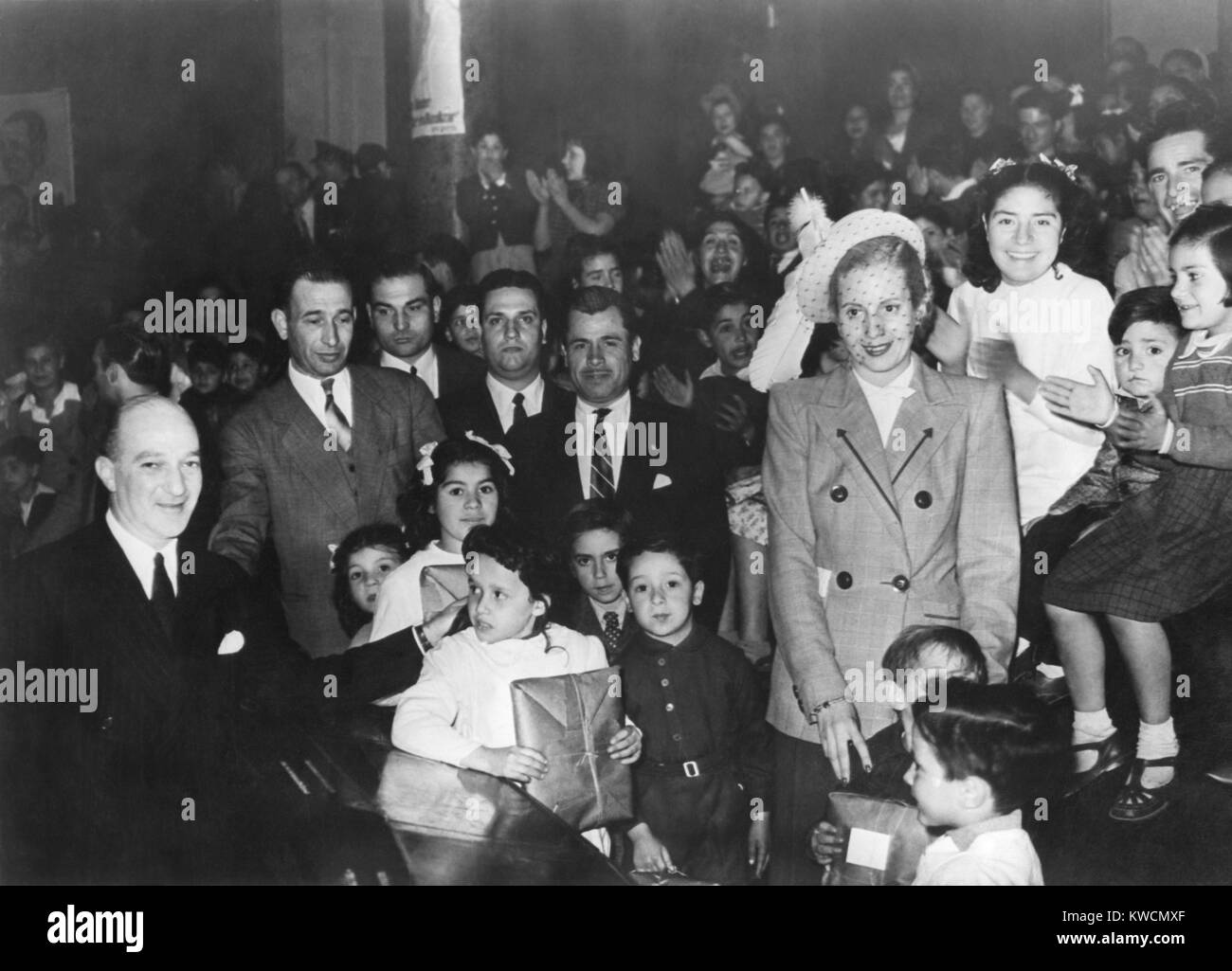 First Lady Eva Peron, distributing gifts to children at the Eva Peron Foundation. With this organization, founded on July 8, 1948, she displaced the society women who previously ran Argentine charitable organizations. - (BSLOC_2014_14_23) Stock Photo