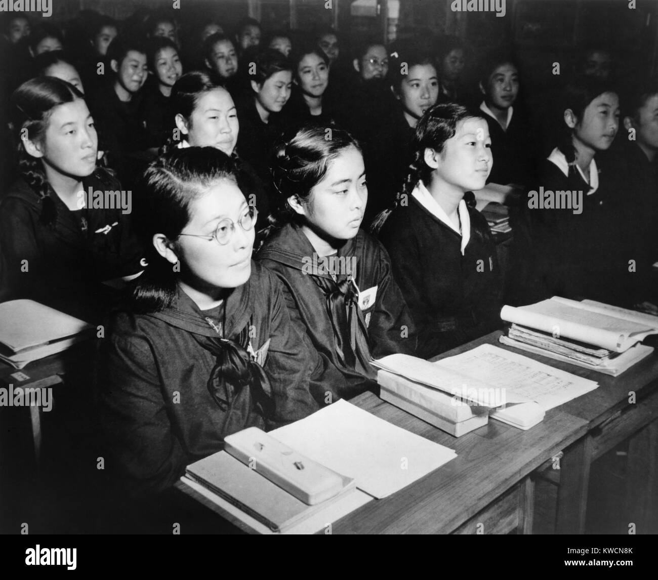 Japanese girls seated at desks in newly rebuilt Catholic school in Tokyo, Japan. The teenagers helped rebuild the school. Oct. 31, 1946. - (BSLOC 2014 15 131) Stock Photo